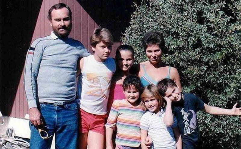 The phoenix family posing for a family photo in the summertime. 
