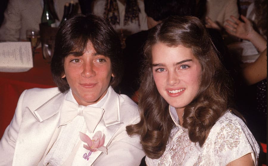 Scott Baio and Brooke Shields posing at a dinner event 