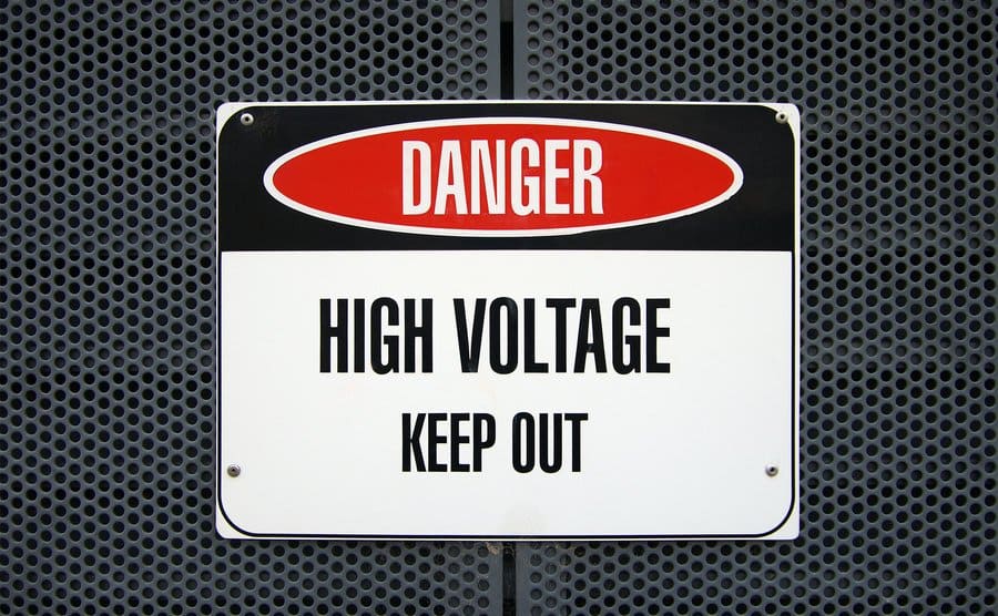 'Danger: High Voltage - Keep Out' sign on a metal housing for electric equipment.