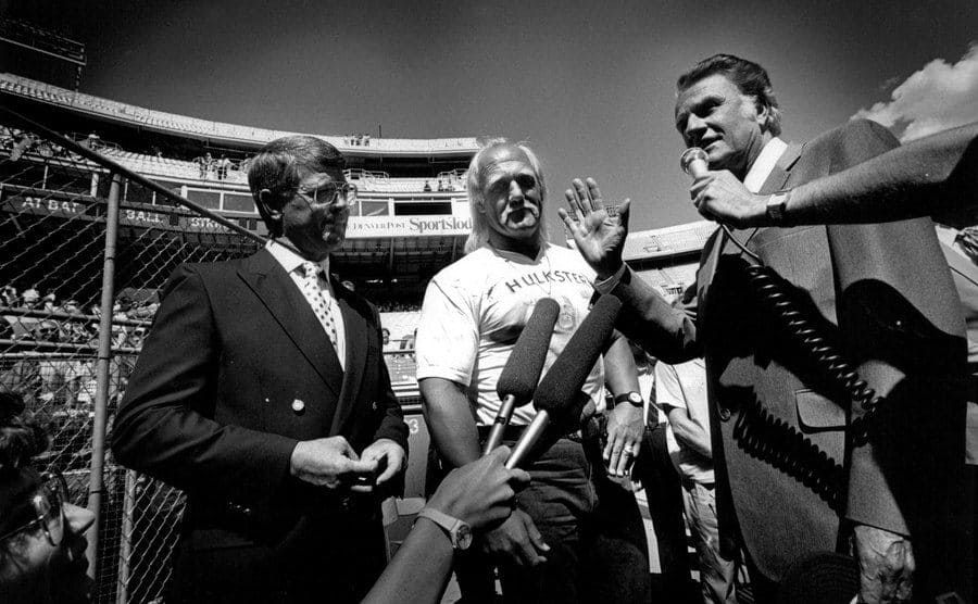 Hulk Hogan with Dan Reeves and Billy Graham speaking to press 