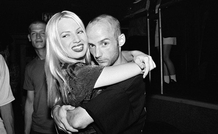 Traci Lords and Moby, a musician, posing together at a club 