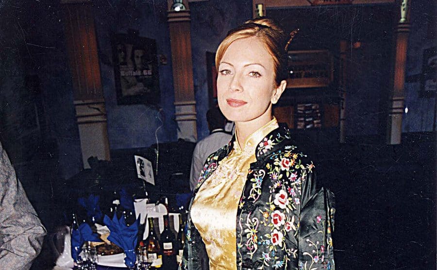 Traci Lords standing and posing at a dinner event 