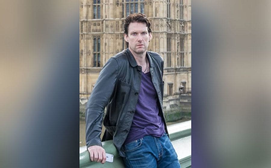 Billy Jensen is posing for a photo in front of Big Ben. 