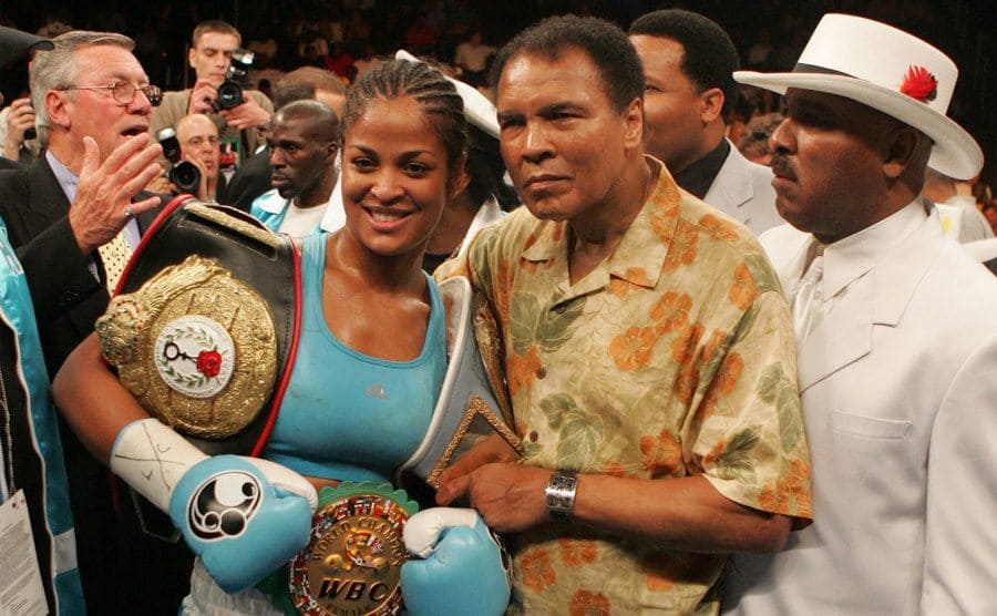 Laila Ali poses with her father, Muhammad Ali, after her 10 round WBC/WIBA Super Middleweight title.
