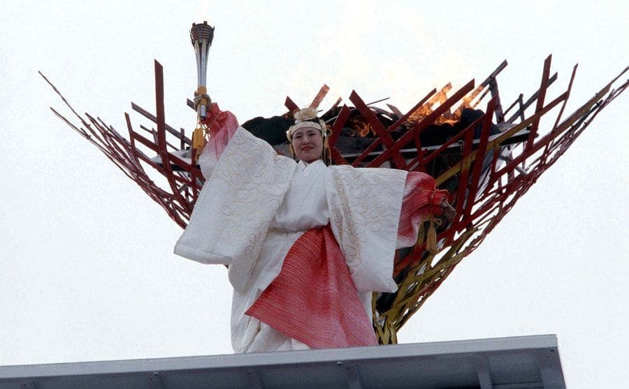 Midori Ito holding the torch at the 1998 Olympics after lighting the torch 