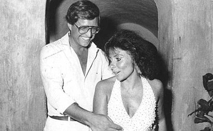 Maurizio Gucci holding onto Patrizia Reggiani at a party. They look like a happy couple. 