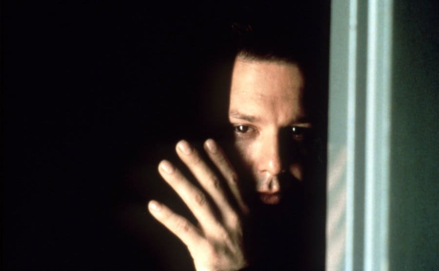 Mickey Rourke is peaking through a crack in the door on the set of ‘Nine 1/2 Weeks’. 