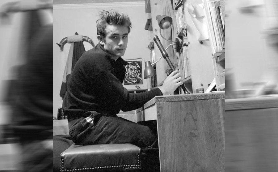 James Dean sitting at his work desk at home 