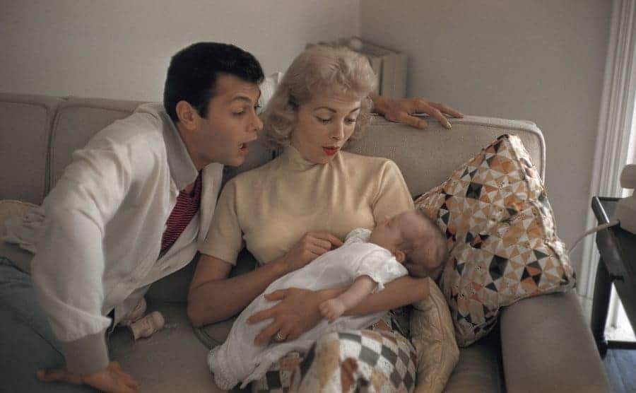 Janet Leigh and Tony Curtis posing for a portrait with their daughter at their home in 1965