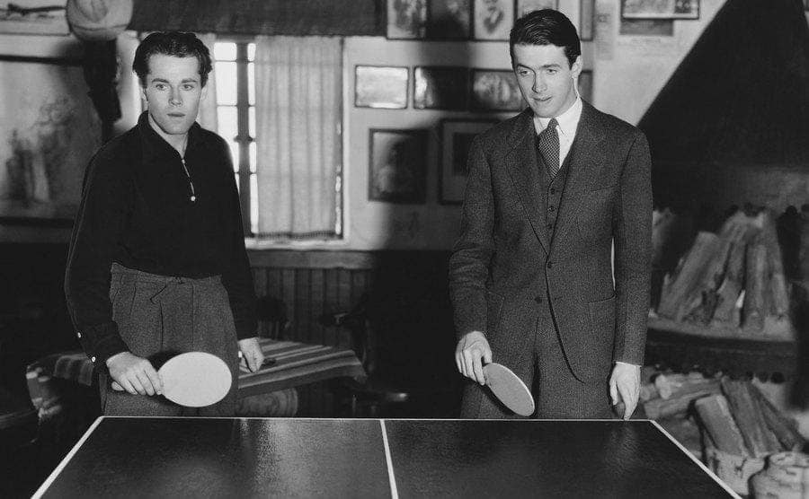 Henry Fonda and James Stewart playing ping pong in Fonda's new home 