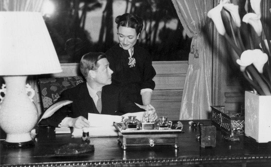 The Duke and Duchess of Windsor sitting behind a desk 