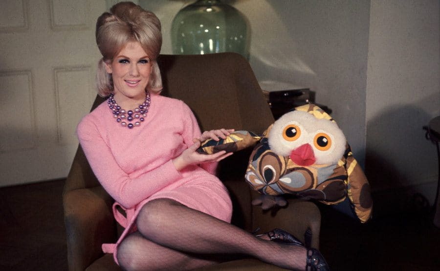 Dusty Springfield sitting in an armchair at her home 