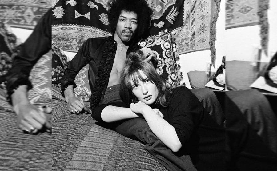 Jimi Hendrix sitting in his bed with Kathy Etchingham at his apartment 