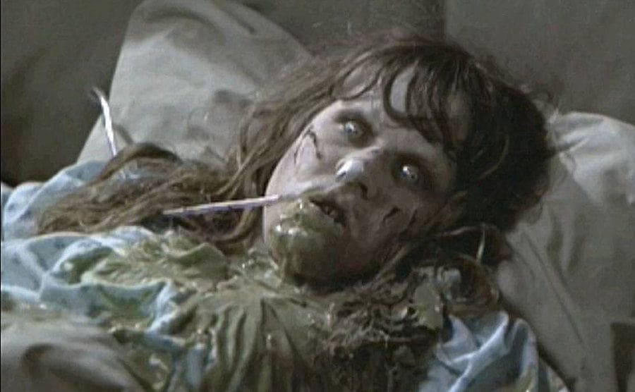 A possessed Linda Blair lying in bed covered in the pea soup “vomit”. 