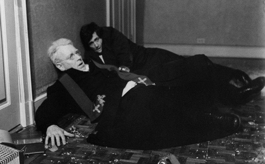Max Von Sydow and Jason Miller lay on the floor after being thrown from bed in a scene from the film 'The Exorcist'