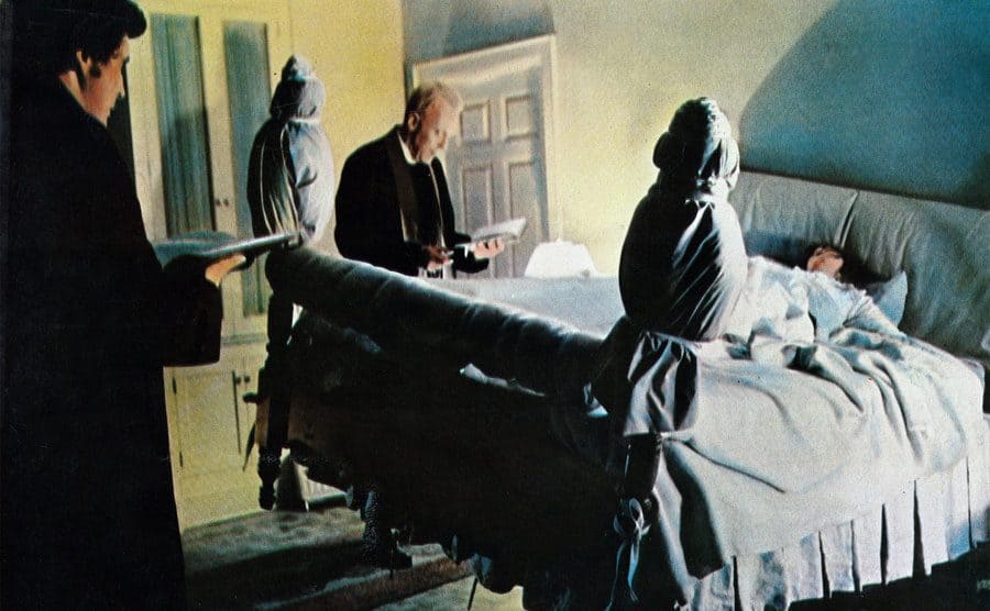 Max von Sydow and Jason Miller are trying to remove the demon from Linda Blair through prayer.