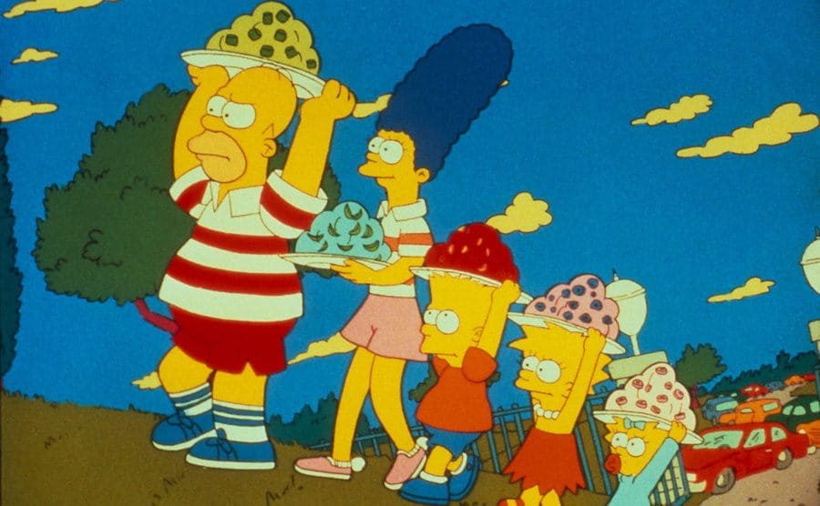 The Simpsons walking up a hill, all holding Jell-O platters.