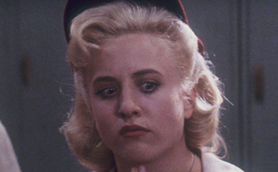 Bitty Schram is deep in thought in a still from A League of Their Own. 