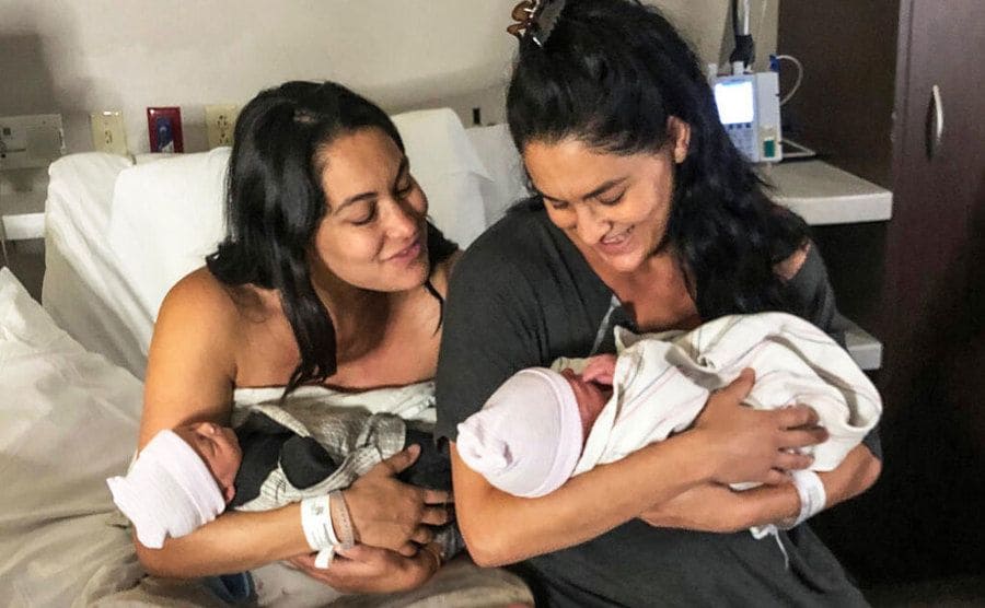 The Bella Twins are holding their baby boys in the hospital. 