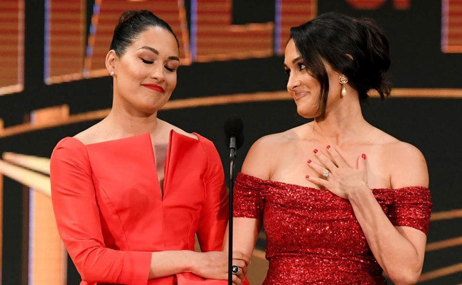 Brie and Nikki speak on stage at their induction ceremony. 