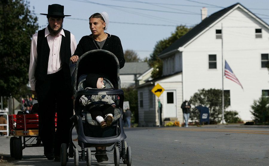 An Amish family walks down the street. 