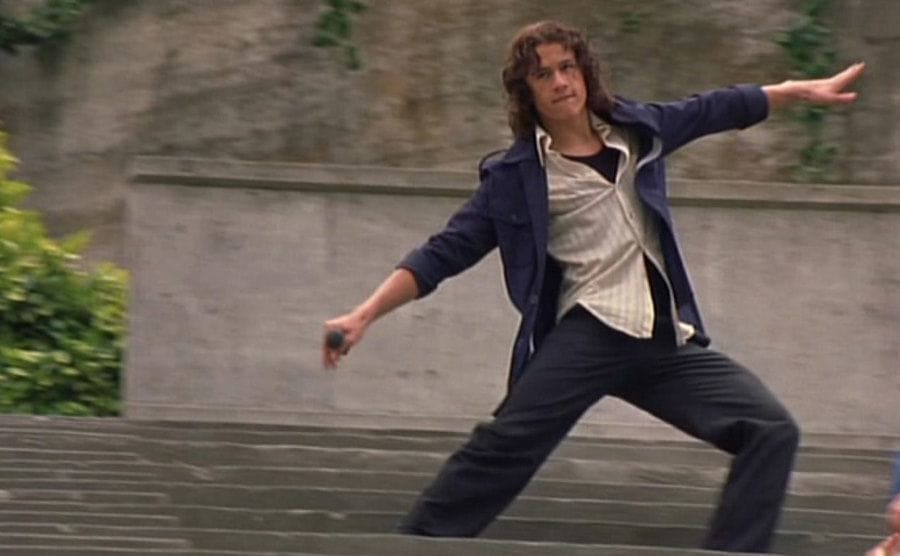 Heath Ledger is dancing across the stadium in a scene from the film “10 Things I Hate About You”. 