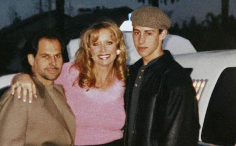 Family photo of Jeff, Susan, and Nicholas, outside a limousine. 