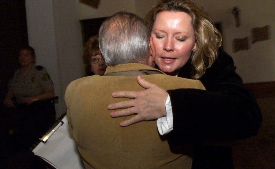 Susan Markowitz is hugging her father-in-law Sam Markowitz after the sentencing of Jesse Hollywood.