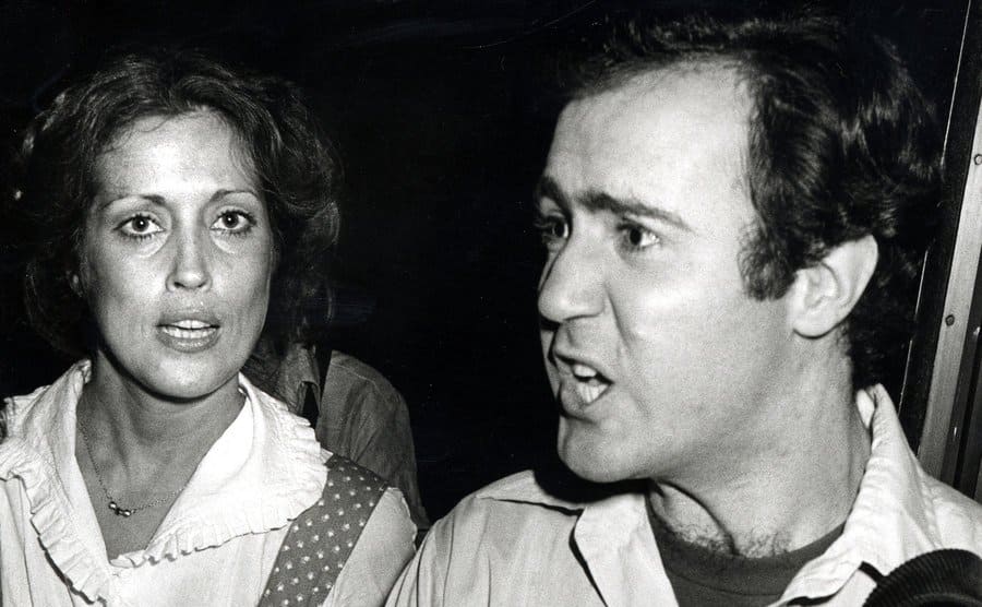 The press takes shots of Andy Kaufman and Charmagne Leland during 