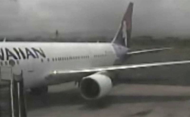 CCTV footage of a teen stowaway coming out of a grounded plane. 