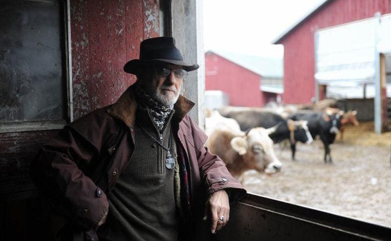 Retired Frank Serpico is standing next to his house on a cow stable. 
