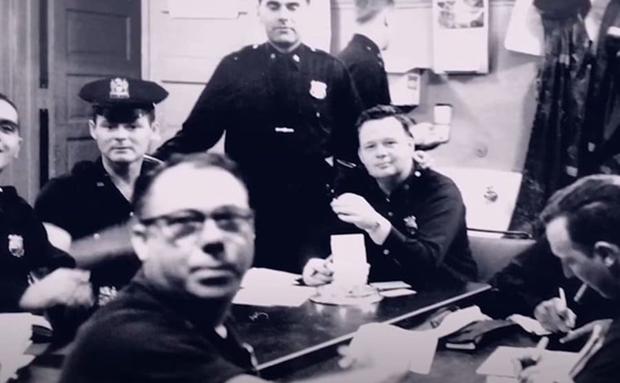 Movie still from Frank Serpico documentary where all the police officers are working at the police headquarters.