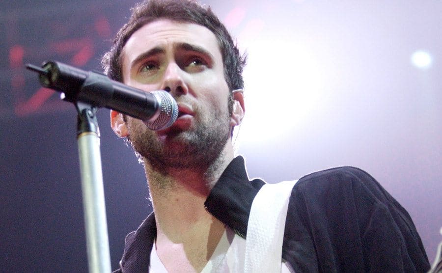 Adam Levine is performing in a Maroon 5 show, circa 2005.