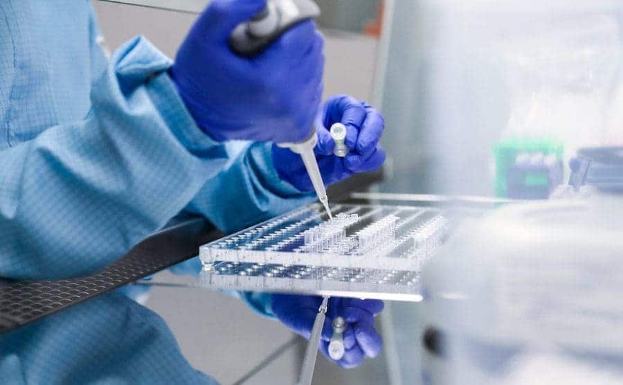 A worker in a lab is doing forensics DNA testing.