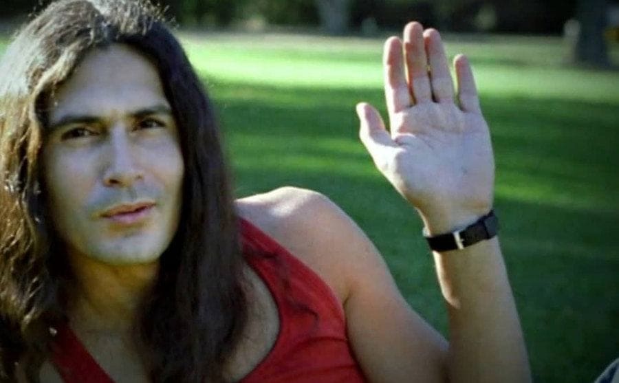 Rodney Alcala is lying on the grass at the park.