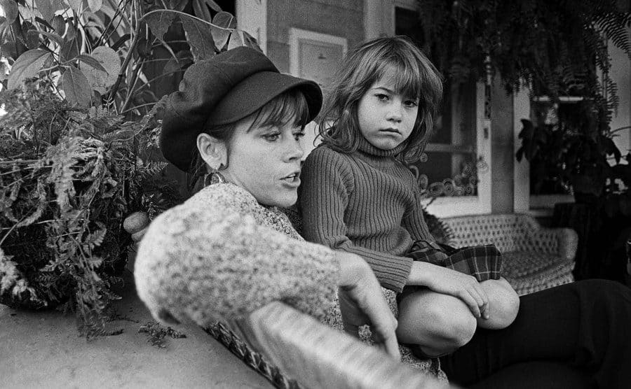 Vanessa sits on Jane Fonda's lap during a portrait session in their house.