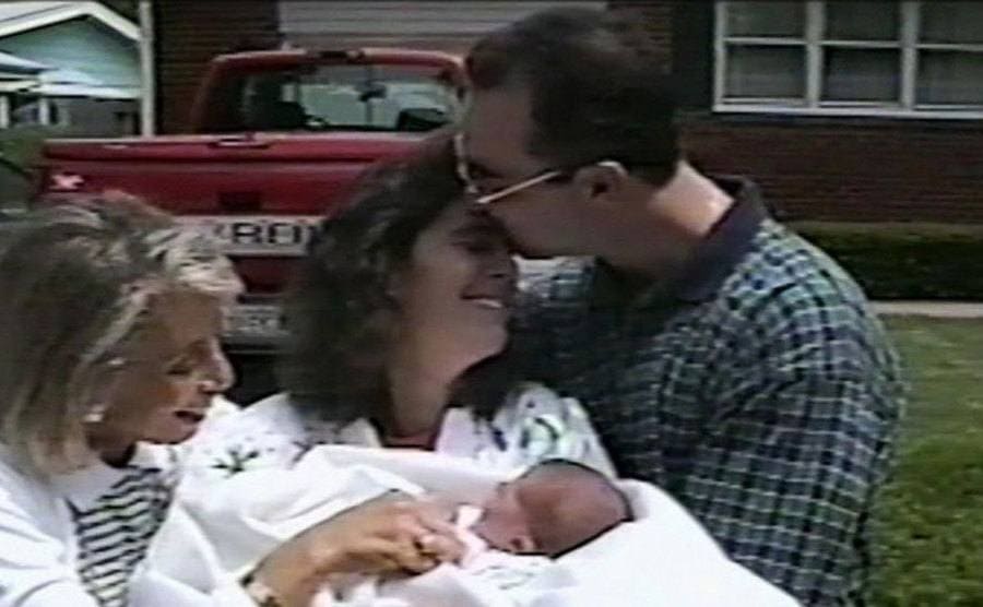 Mark kisses Donnah on the forehead as they welcome their baby home. 