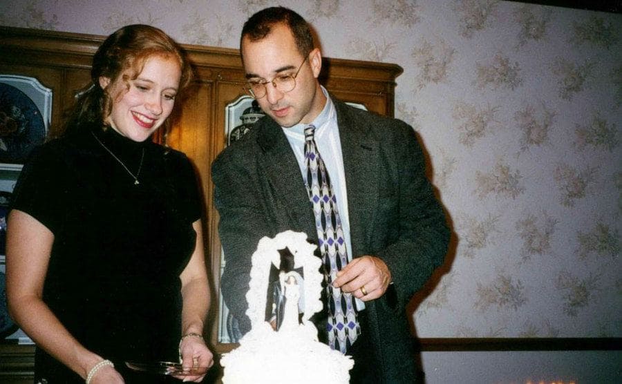 Mark and Rebecca cut into their wedding cake. 