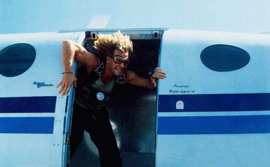 Swayze, as Bodhi, is preparing to skydive out of a plane. 