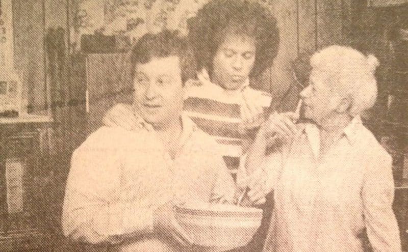 Richard Simmons stands between his brother and his mother as they cook at home.