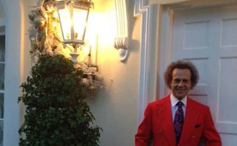Richard Simmons poses as he stands on his doorstep. 