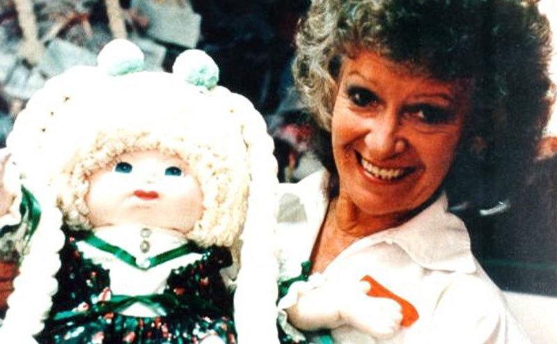 Betty Lou smiles while holding a doll.