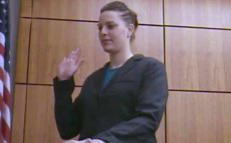 Ashley takes an oath before testifying in court. 