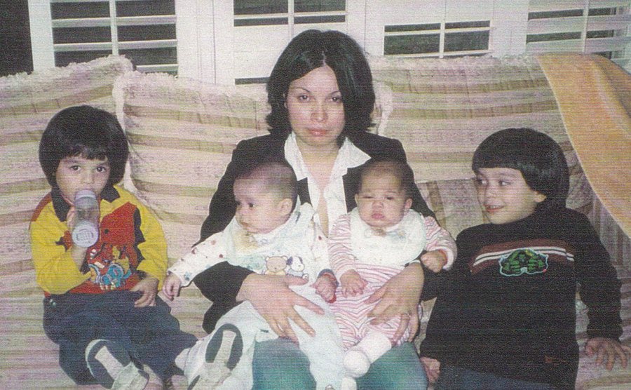 Maria Bruno and her children sitting in the couch. 