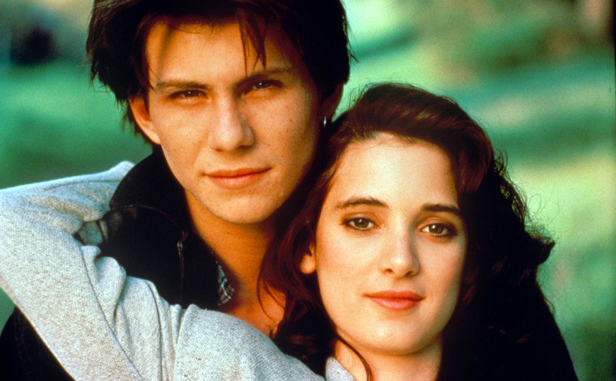 Winona Ryder is leaning on Christian Slater in Heathers. 