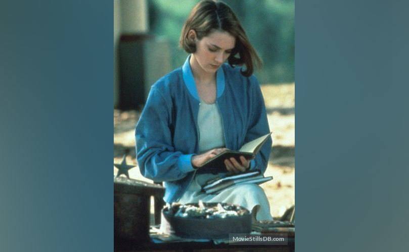 Winona Ryder is reading a book. 