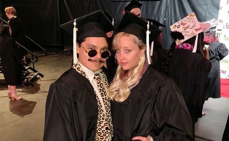 Amanda Bynes poses with a friend at her graduation from FIDM.