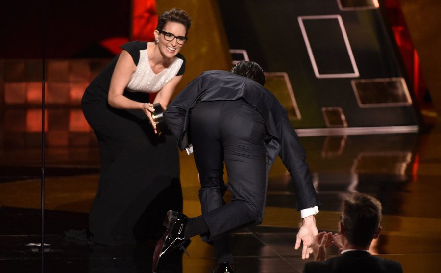 Jon Hamm falls as he makes his way to the stage.