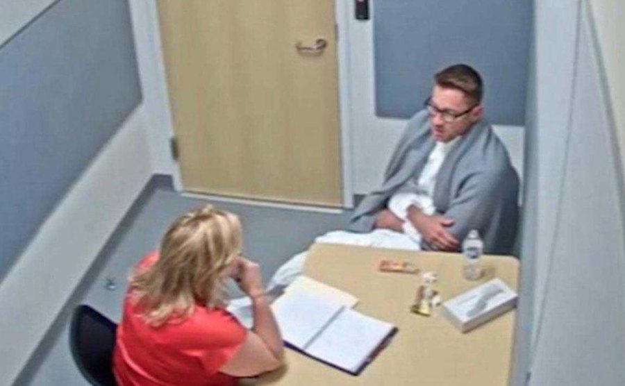 Detectives examine Dave Tronnes in the interrogation room.
