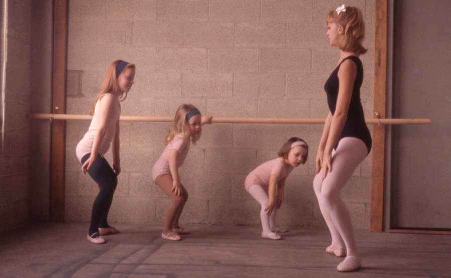 Goldie Hawn demonstrates a position for her young ballet students.